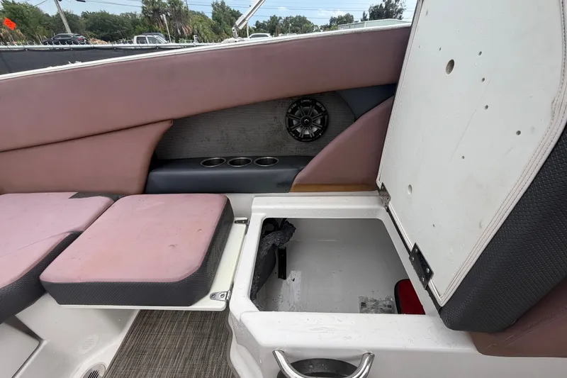 Slide: The Image of Interior of a 2018 Scarab 255 ID boat showing seating and storage compartment. - 60