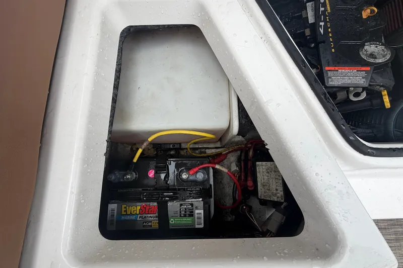 Slide: The Image of Battery compartment of a 2018 Scarab 255 ID boat with EverStart Marine battery. - 66