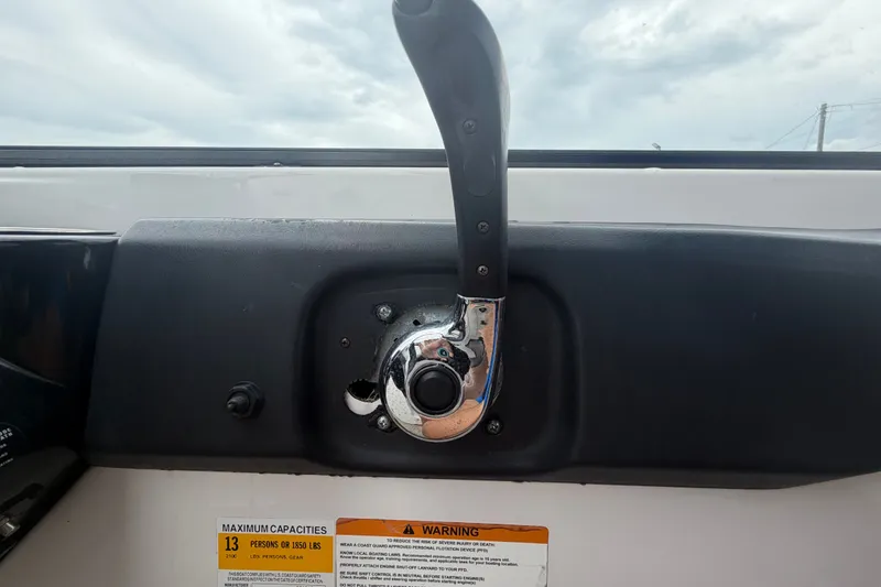 Slide: The Image of Throttle control lever on a 2018 Scarab 255 ID boat dashboard. - 29