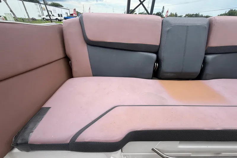 Slide: The Image of Interior seating of a 2018 Scarab 255 ID boat, featuring pink and gray upholstery. - 71