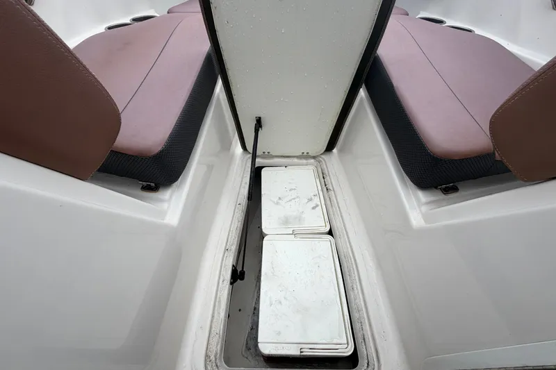 Slide: The Image of Interior view of a 2018 Scarab 255 ID boat, featuring seating and storage compartments. - 40
