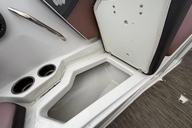 Slide: The Image of Open storage compartment in 2018 Scarab 255 ID boat interior with cup holders. - 49
