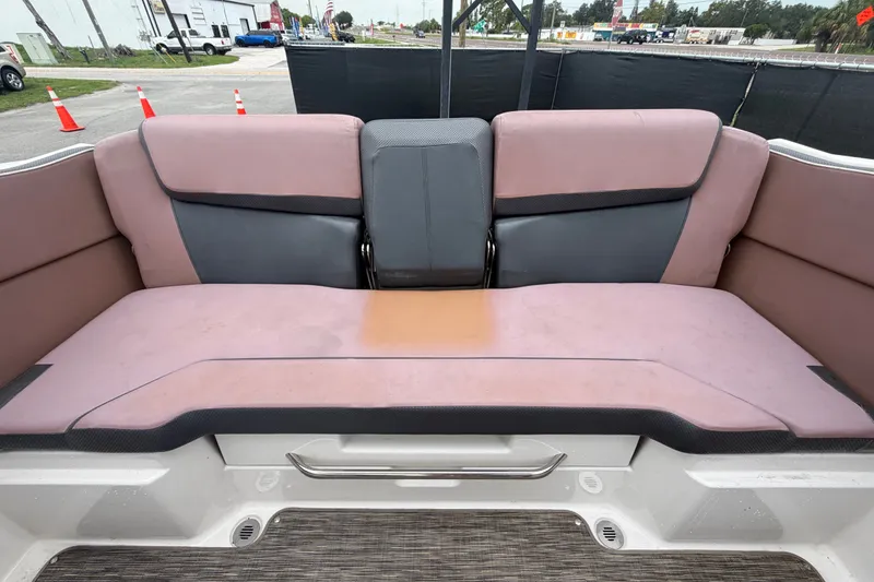 Slide: The Image of Rear seating area of a 2018 Scarab 255 ID boat, featuring cushioned upholstery. - 64