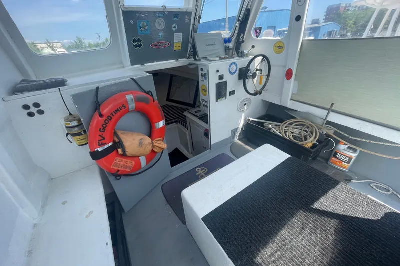 Slide: The Image of Interior of a 1996 Outlaw Marine 25' OUTLAW boat with steering wheel and safety equipment. - 10