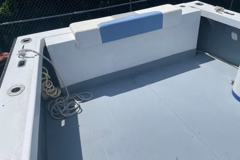Slide: The Image of 1996 Outlaw Marine 25' boat deck with seating and coiled ropes. - 17