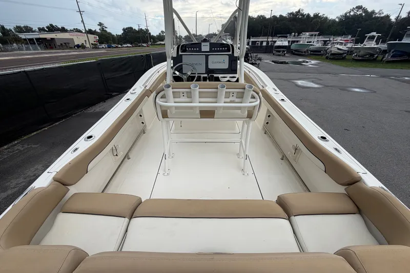 Slide: The Image of 2021 Pioneer 222 Islander boat interior with beige seating and Garmin navigation system. - 13