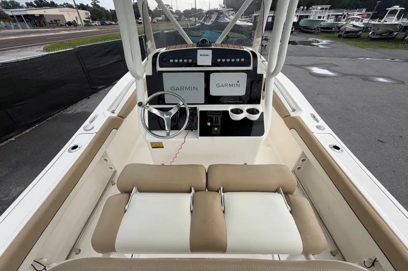 Slide: The Image of 2021 Pioneer 222 Islander boat interior with Garmin navigation system and steering wheel. - 17