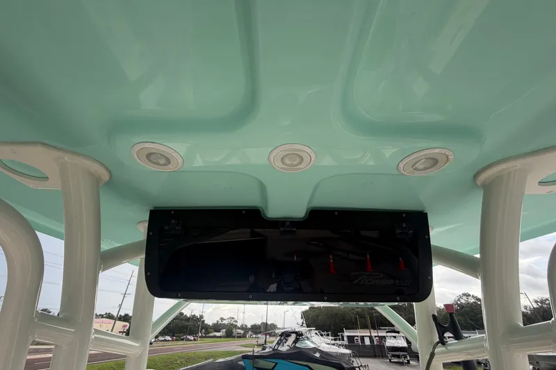 Slide: The Image of 2021 Pioneer 222 Islander boat interior with teal ceiling and built-in lighting. - 19