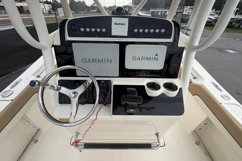Slide: The Image of 2021 Pioneer 222 Islander boat dashboard with Garmin displays and Suzuki controls. - 18