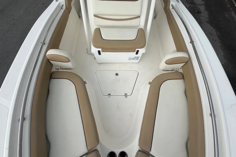 Slide: The Image of Interior view of a Pioneer 222 Islander boat with beige and white seating. - 49