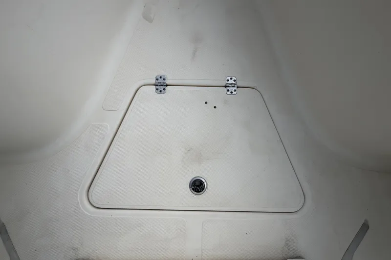 Slide: The Image of A white storage hatch with hinges on a boat. - 38