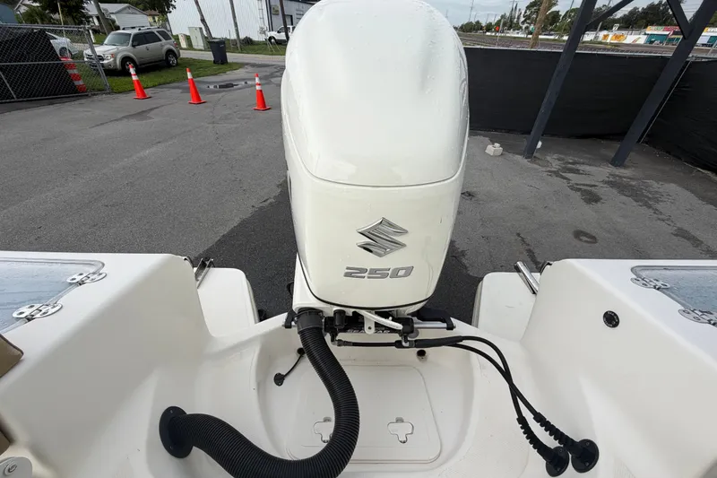 Slide: The Image of Outboard motor on a 2021 Pioneer 222 Islander boat, parked on pavement. - 64