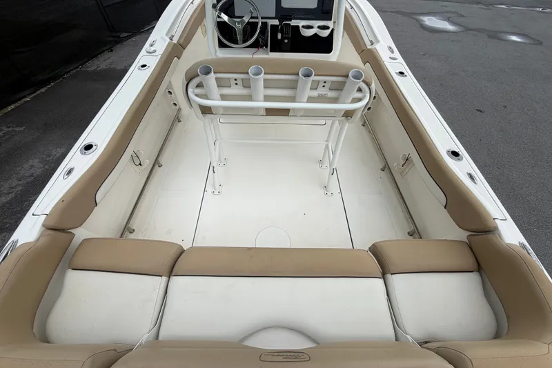 Slide: The Image of 2021 Pioneer 222 Islander boat interior with beige seating and rod holders. - 15