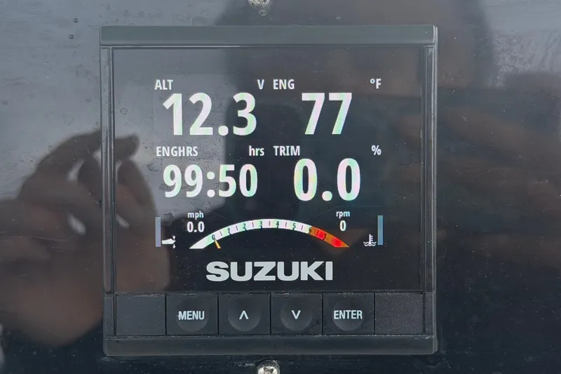 Slide: The Image of Suzuki engine display showing altitude, engine hours, and temperature on Pioneer 222 Islander, 2021 model. - 24