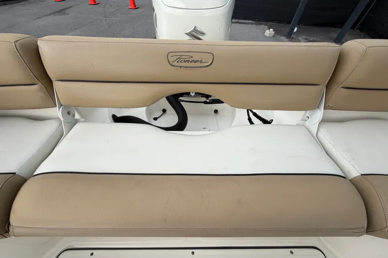 Slide: The Image of 2021 Pioneer 222 Islander boat seating with tan and white upholstery. - 57