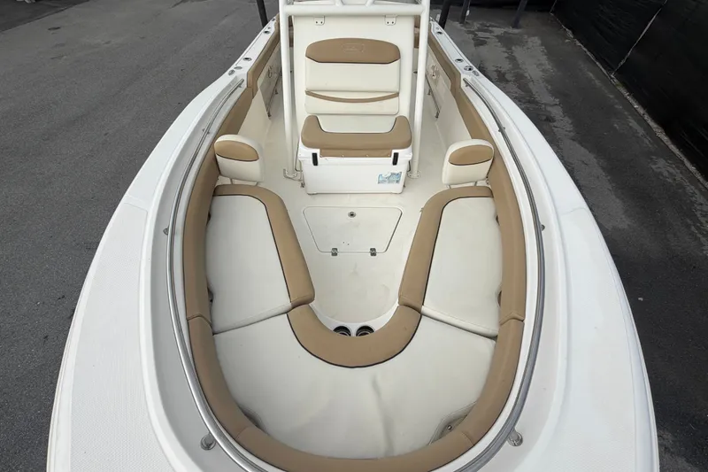Slide: The Image of 2021 Pioneer 222 Islander boat interior with tan and white seating. - 47