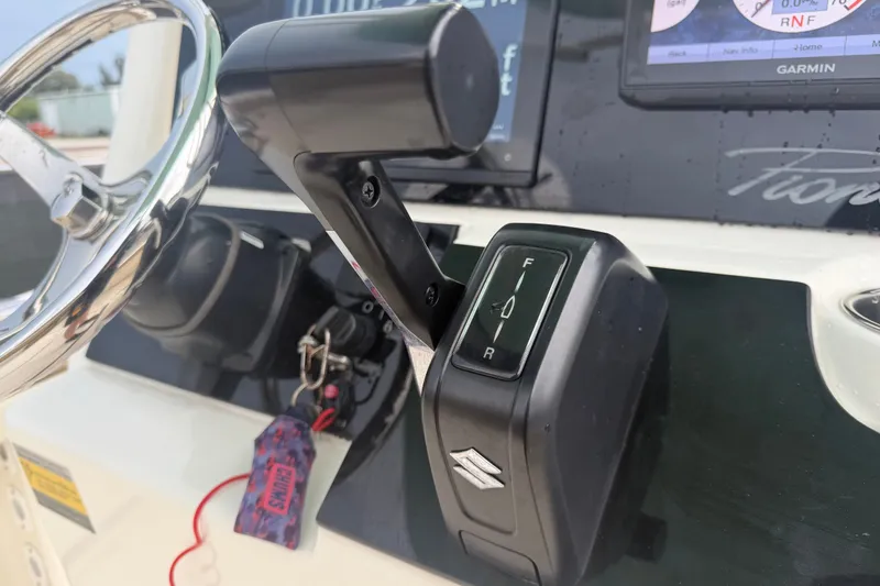 Slide: The Image of Close-up of 2021 Pioneer 222 Islander boat controls and steering wheel. - 29
