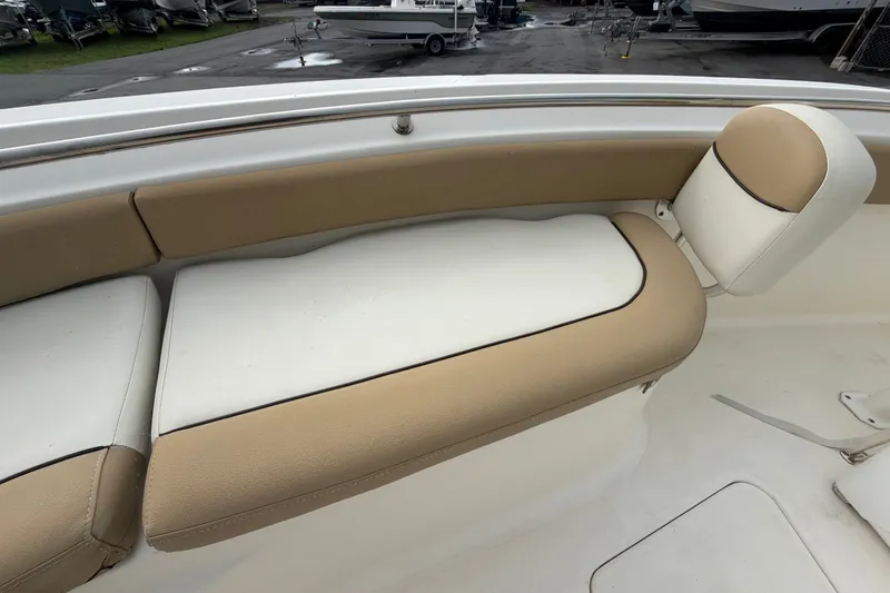 Slide: The Image of 2021 Pioneer 222 Islander boat interior with beige and white cushioned seating. - 45