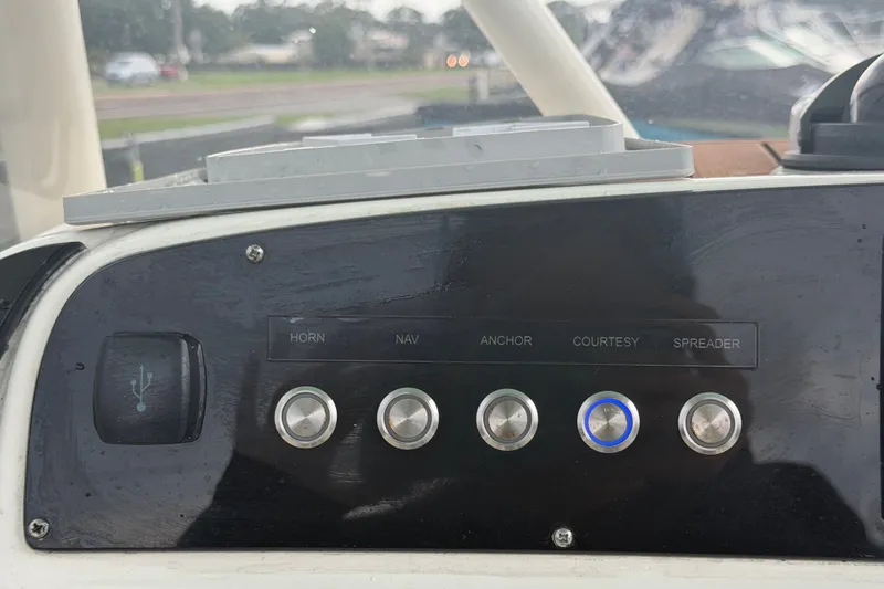 Slide: The Image of Control panel of a 2021 Pioneer 222 Islander boat with labeled switches. - 23