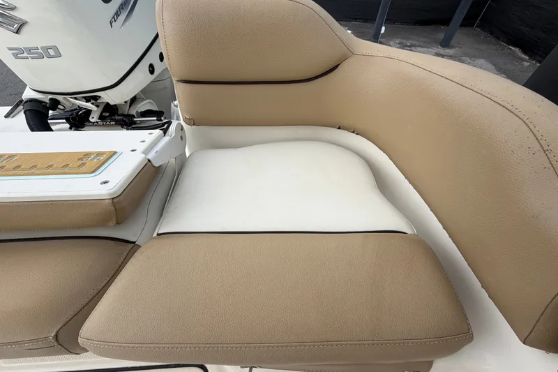 Slide: The Image of Tan and white seating on a 2021 Pioneer 222 Islander boat with Suzuki 250 engine. - 59