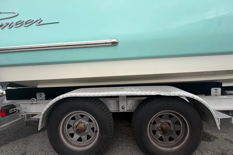 Slide: The Image of 2021 Pioneer 222 Islander boat on trailer, showcasing side view and wheels. - 71