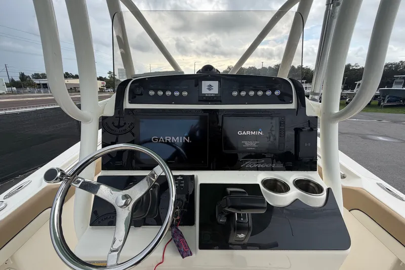 Slide: The Image of 2021 Pioneer 222 Islander boat dashboard with Garmin navigation system and steering wheel. - 22