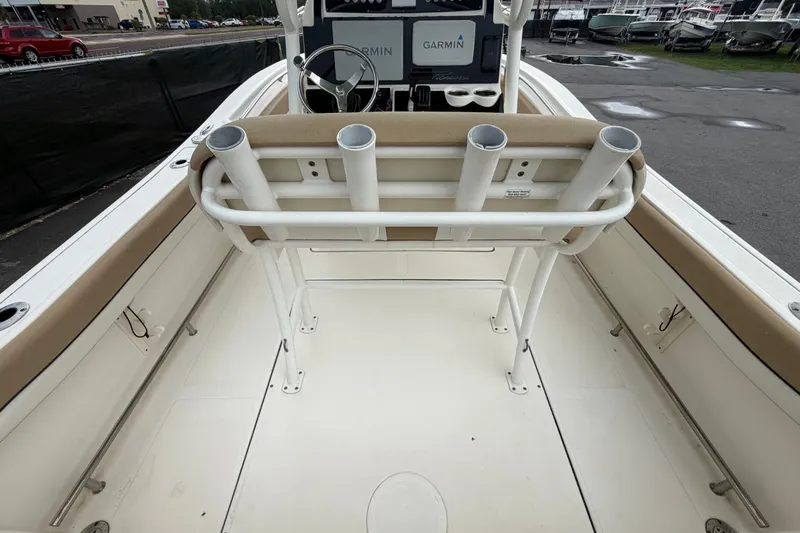 Slide: The Image of 2021 Pioneer 222 Islander boat interior with rod holders and Garmin navigation system. - 16