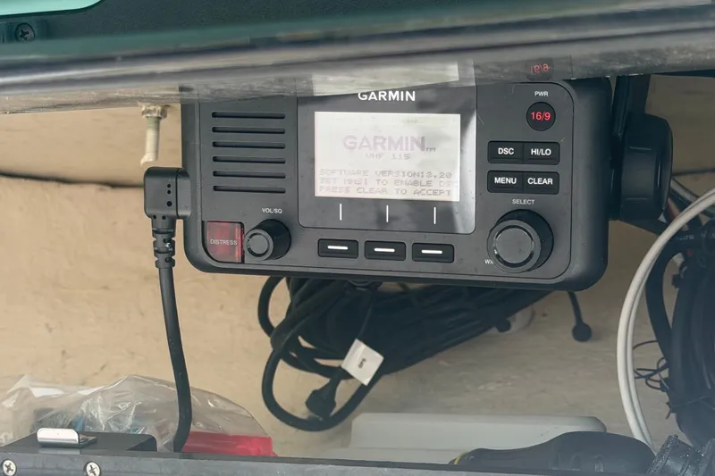 Slide: The Image of Garmin marine radio on 2021 Pioneer 222 Islander boat, featuring distress button and display screen. - 21