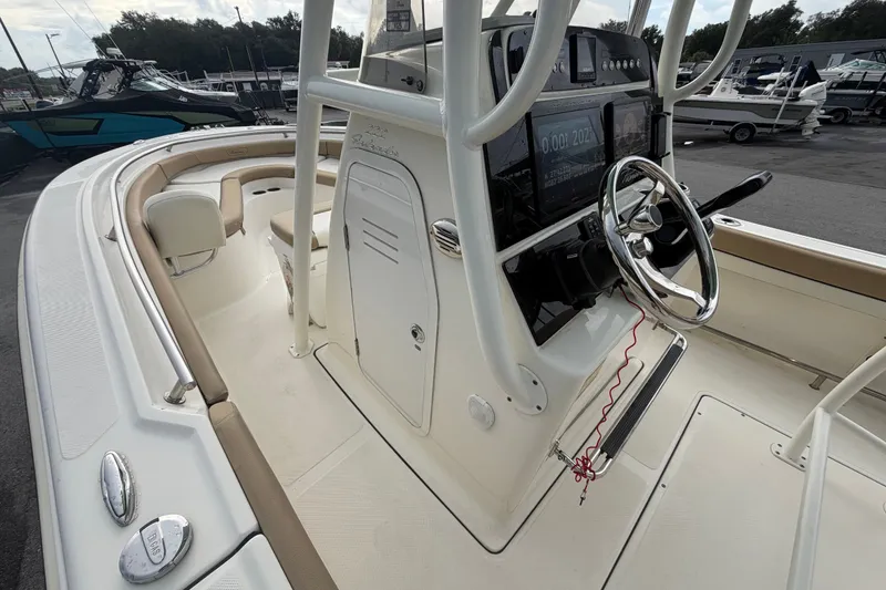 Slide: The Image of 2021 Pioneer 222 Islander boat interior with steering wheel and control panel. - 30