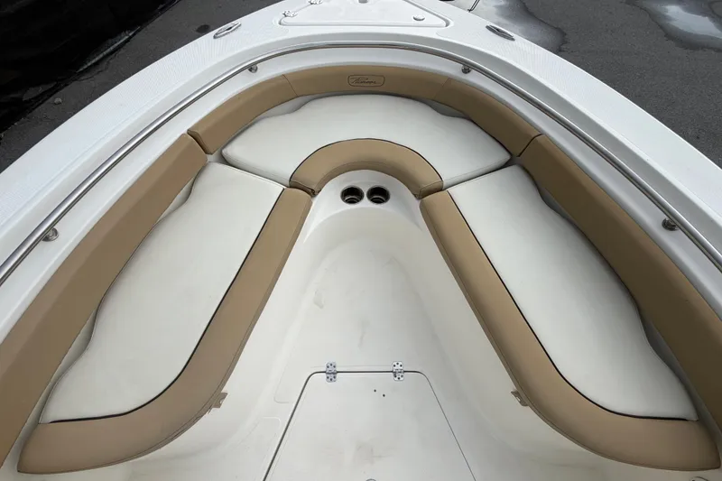 Slide: The Image of 2021 Pioneer 222 Islander boat interior with tan and white cushioned seating. - 37