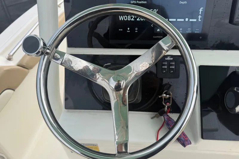 Slide: The Image of Steering wheel of a 2021 Pioneer 222 Islander boat with GPS display. - 28