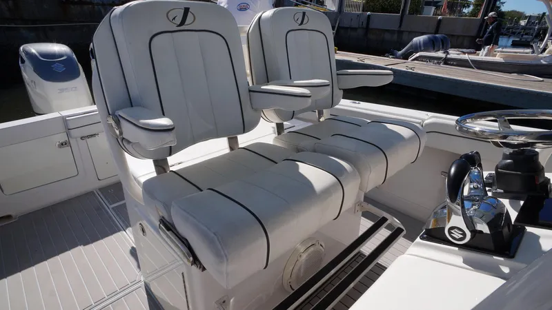 Slide: The Image of 2015 Jupiter 30 FS boat with dual white captain's chairs and steering console. - 16