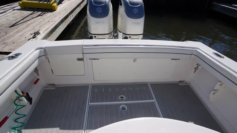 Slide: The Image of 2015 Jupiter 30 FS boat deck with twin engines and storage compartments. - 13