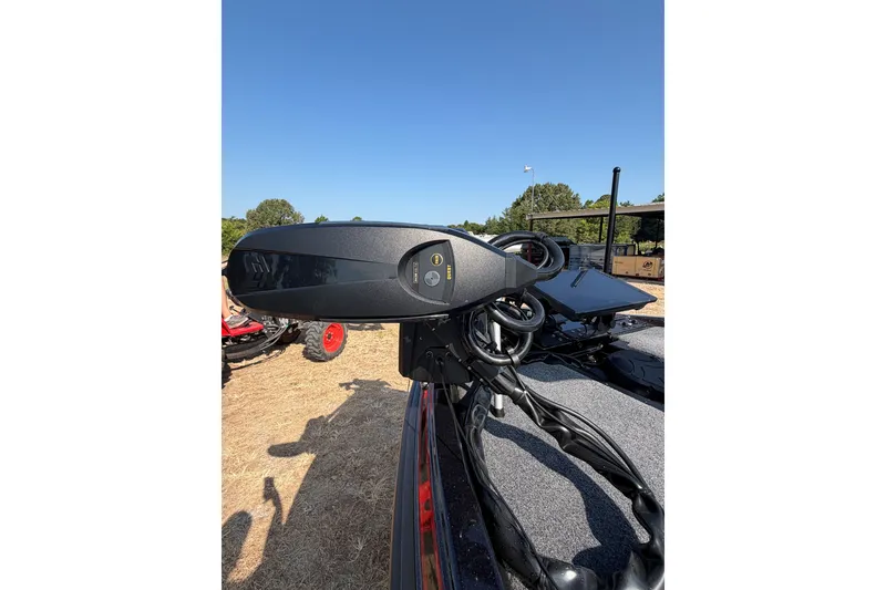 Slide: The Image of 2026 Phoenix 921 Elite X II boat motor on dry land, clear blue sky background. - 4