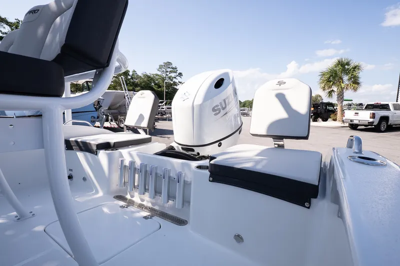 Slide: The Image of 2026 Sea Pro 202 Center Console boat interior with Suzuki engine, featuring seating and rod holders. - 17