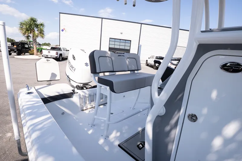 Slide: The Image of 2026 Sea Pro 202 Center Console boat with Suzuki engine, parked outdoors. - 15
