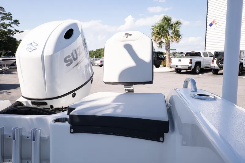 Slide: The Image of 2026 Sea Pro 202 Center Console boat with Suzuki outboard motor in a parking lot. - 18