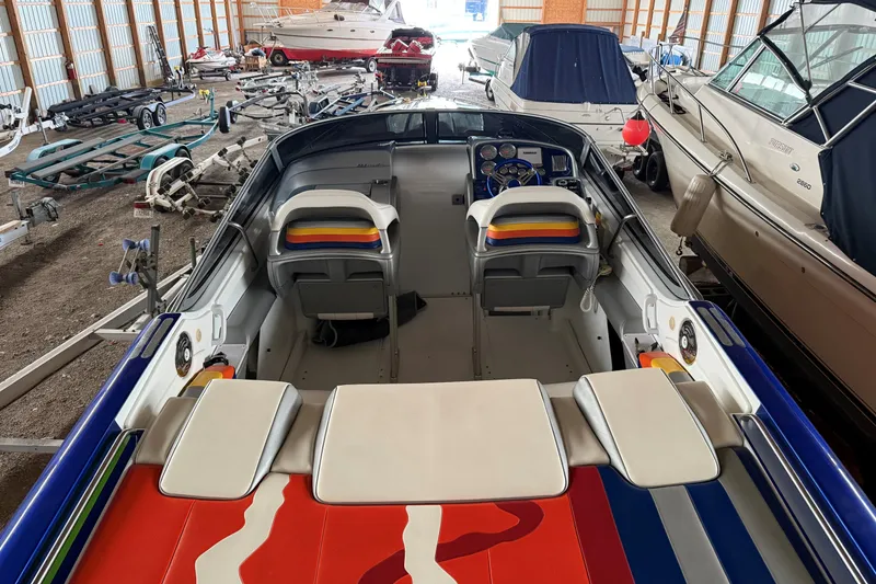 Slide: The Image of 2008 Formula 353 FASTech boat interior in storage, showcasing colorful seating and dashboard. - 22