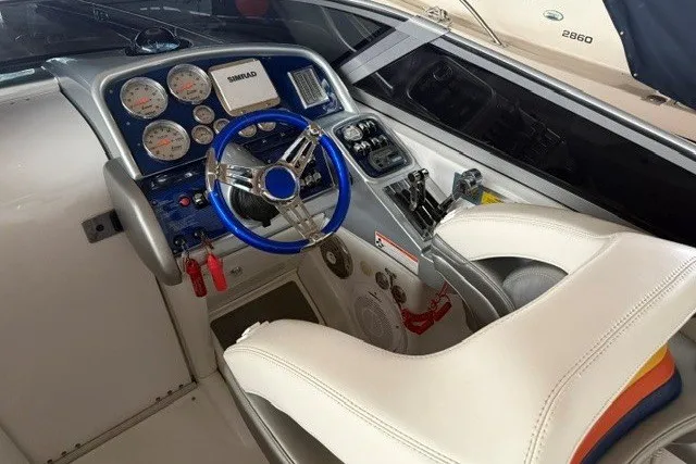 Slide: The Image of 2008 Formula 353 FASTech boat cockpit with blue steering wheel and instrument panel. - 12