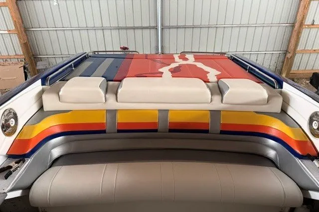 Slide: The Image of 2008 Formula 353 FASTech boat with colorful seating and vibrant design in a storage area. - 17