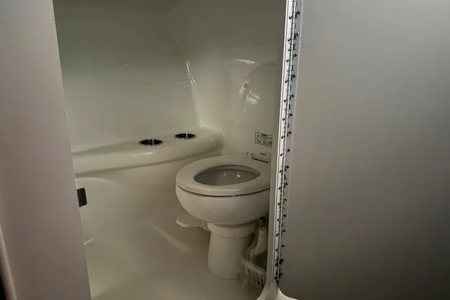 Slide: The Image of 2008 Formula 353 FASTech boat bathroom interior with white fixtures and compact design. - 34