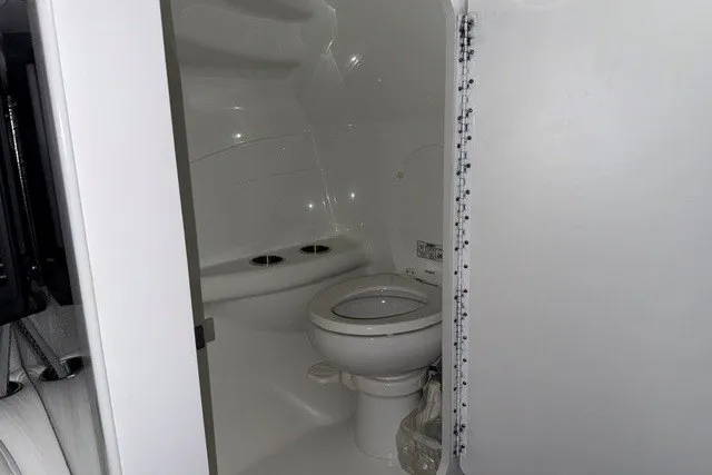Slide: The Image of 2008 Formula 353 FASTech boat bathroom with white interior and compact design. - 7