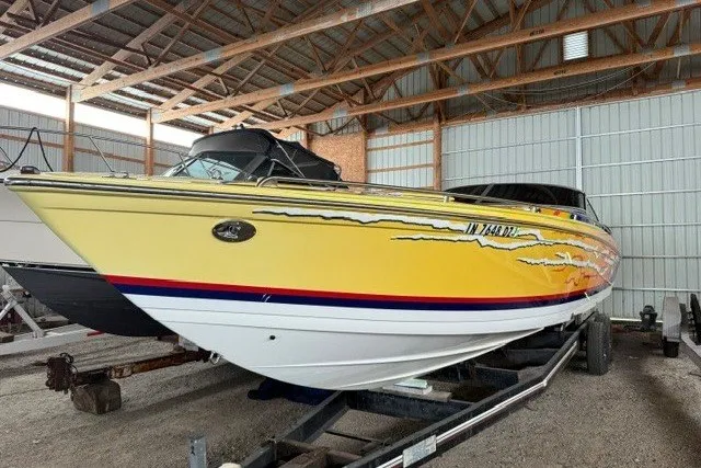 Slide: The Image of 2008 Formula 353 FASTech boat in storage, featuring a vibrant yellow and white design. - 1