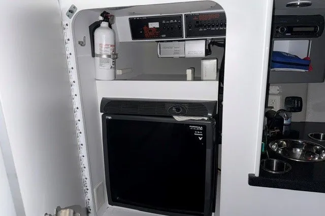 Slide: The Image of 2008 Formula 353 FASTech cabin interior with fridge, fire extinguisher, and control panels. - 11