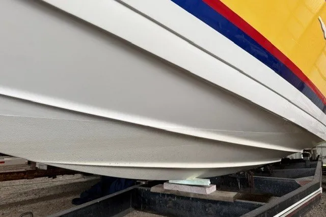 Slide: The Image of 2008 Formula 353 FASTech boat hull with vibrant yellow and red accents on trailer. - 4