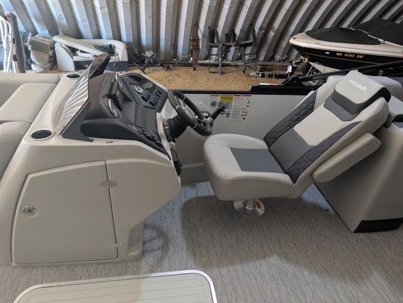 Slide: The Image of Sylvan L3 LZ DH 2026: Modern helm with gray seat and dashboard in a covered area. - 13