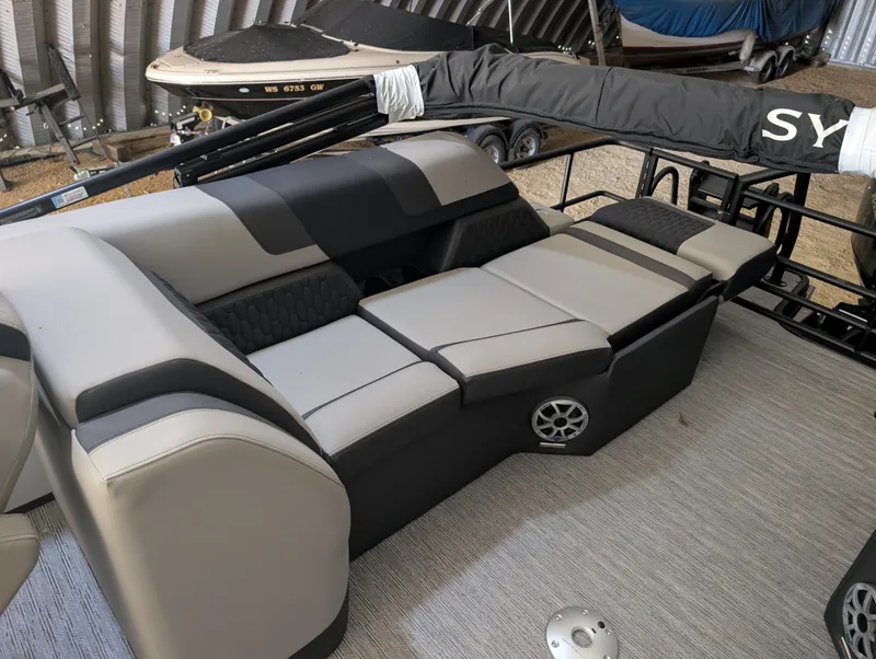 Slide: The Image of The image shows the interior of a 2026 Sylvan L3 LZ DH with gray and black seating. - 18