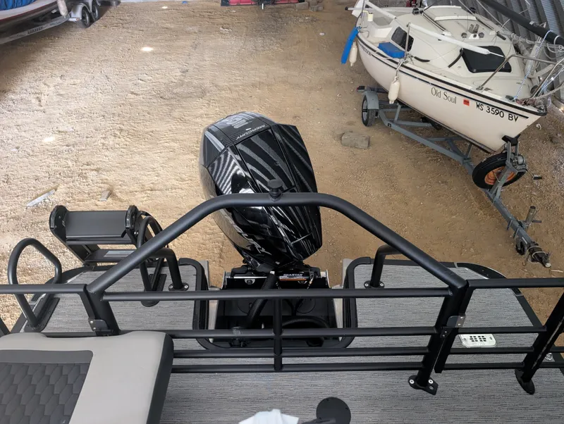 Slide: The Image of The image shows the rear of a Sylvan L3 LZ DH boat with an outboard motor. - 19
