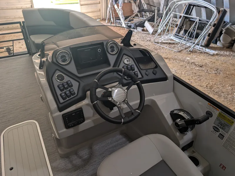 Slide: The Image of The image shows the helm of a 2026 Sylvan L3 LZ DH boat with modern controls. - 14
