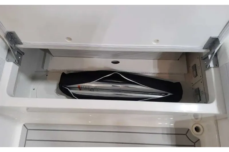 Slide: The Image of Ein Staufach auf einem Boot mit einem zusammengeklappten Sonnenschirm oder Zelt in einer Tasche. - 26